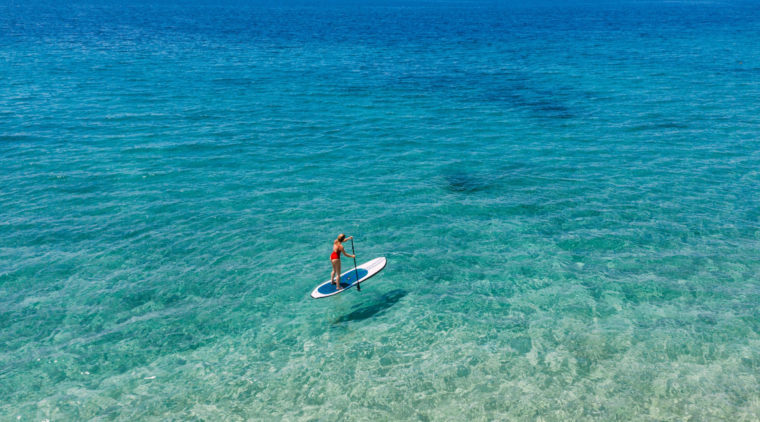 Aerial view of woman riding paddleboard